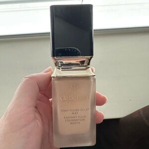 Clé de Peau Radiant Fluid Foundation with Black Cap and Gold Trim